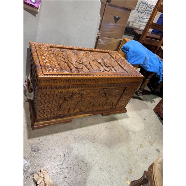 Carved African themed chest measures 35" x 19 1/4" x 18 1/2"
