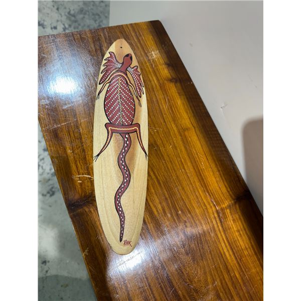 Australian Aboriginal bullroarer, which is a traditional musical instrument and artifact.