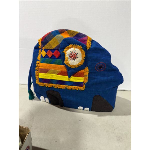 Handcrafted teapot cover has spout hole for trunk