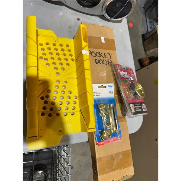 Saw guide pocket door item, door chain, and passage door handle