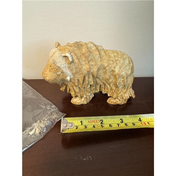 carving of a muskox needs a bit of repair