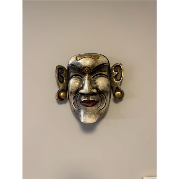 Indonesian carved mask with gold leaf