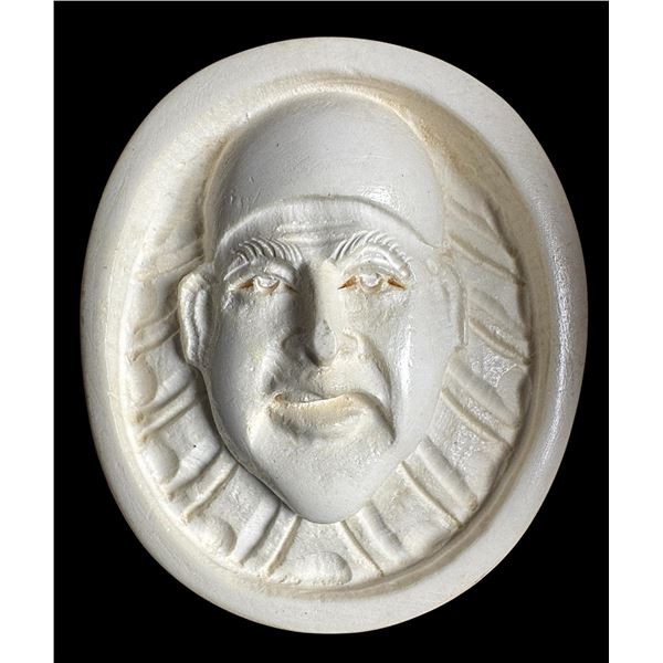 A division three carved white material pictorial button