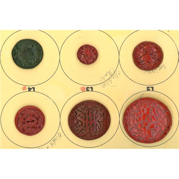 A small card of division one Cinnabar buttons