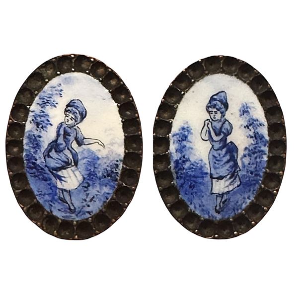 A pair of division one oval figural enamel buttons