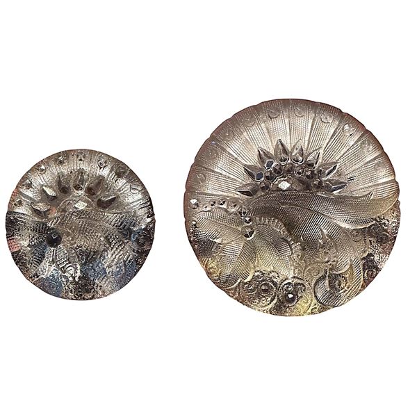 A pair of division one lacy glass buttons