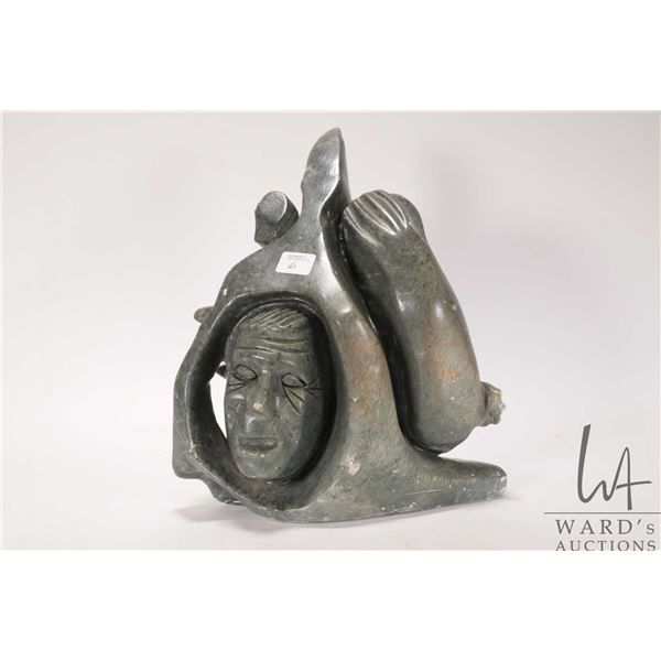 Hand carved Inuit three sided soapstone including Inukshuk, face and a seal, artist signed on base, 