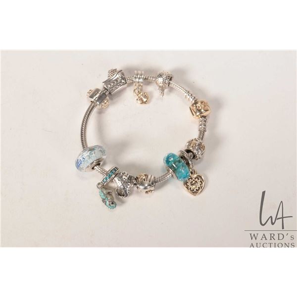 Genuine Pandora bracelet with eleven mostly sea themed Pandora charms including gold star fish and a