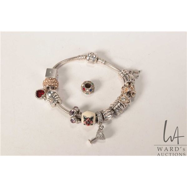 Genuine Pandora bracelet with twelve Pandora charms including dice, enameled Christmas pudding, cham