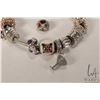 Image 5 : Genuine Pandora bracelet with twelve Pandora charms including dice, enameled Christmas pudding, cham