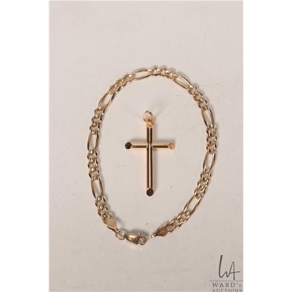 10kt yellow gold 7 1/2" curb chain and a 10kt yellow gold cross pendant