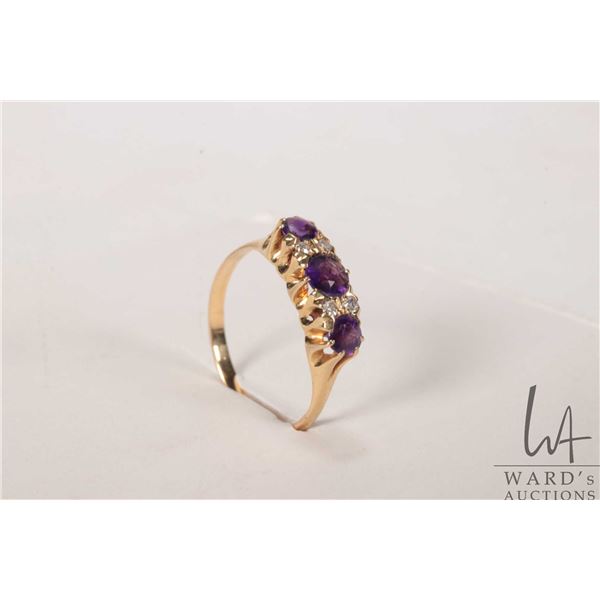 Vintage 18kt yellow gold ring set with three amethyst gemstones and four accent diamonds, size 6.25
