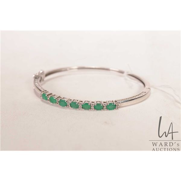 Sterling silver hinged bracelet set with electronically tested gemstones