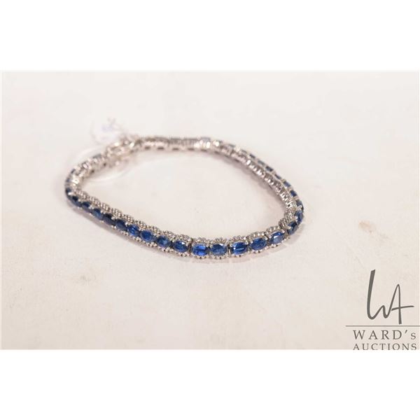 Sterling silver tennis bracelet set with sapphire/ sapphire like electronically tested gemstones, 7.
