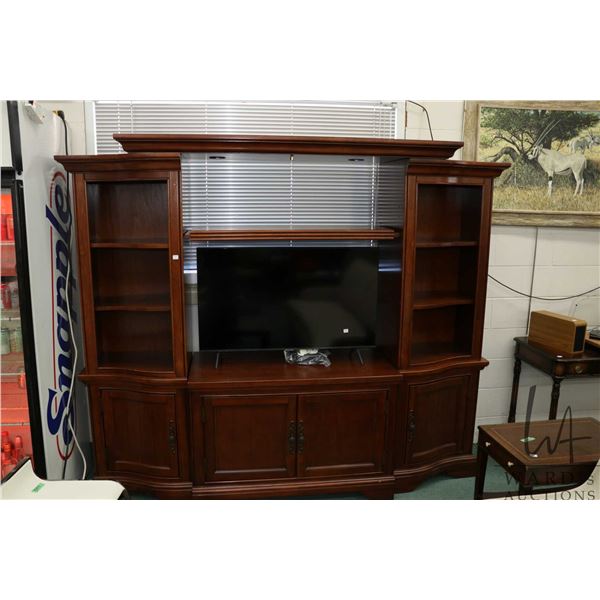 Multi piece entertainment cabinet, overall dimensions 75" H x 85" W x 18" D and can accomodate 42" w