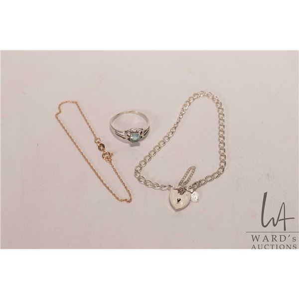 Sterling silver linked bracelet with heart shaped locket fastener, a 10kt yellow gold linked bracele