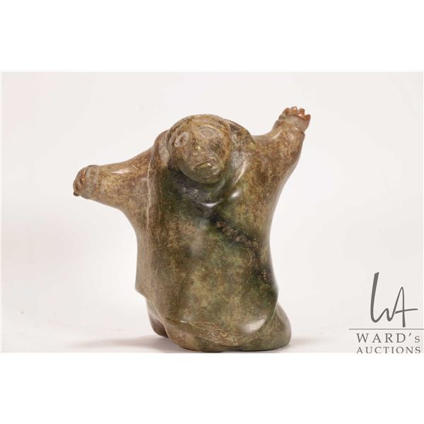 Hand carved Inuit soapstone kneeing figure with Canada Eskimo Art label and numbered 13295, no artis