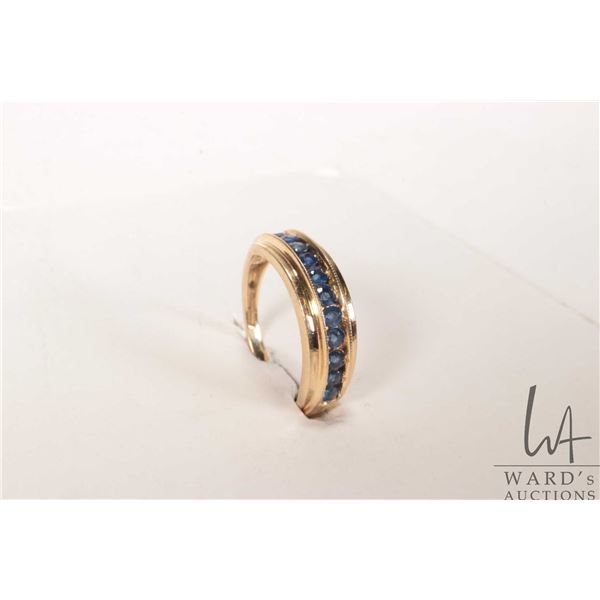 14kt yellow ring with channel set sapphire/ sapphire like gemstones, size 5