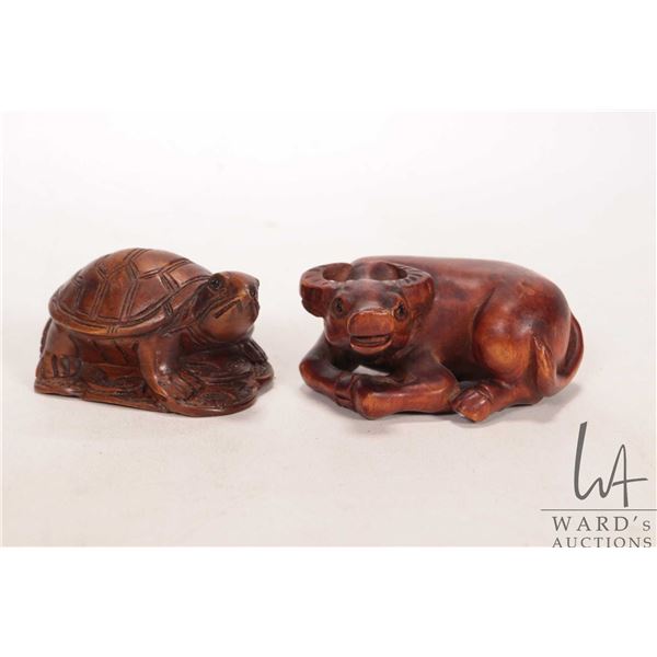 Two artist signed, hand carved wooden netsukes, each approximately 2" in length