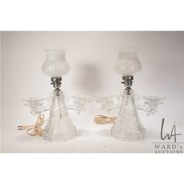 Two vintage electric bedside lamps with glass bases, candle holders and satin glass etched shades