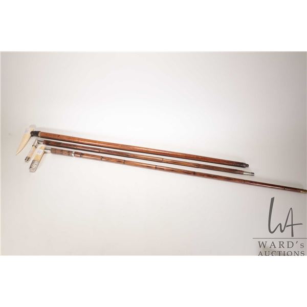 Three vintage/ antique wooden canes with bone or antler handles, two with sterling silver