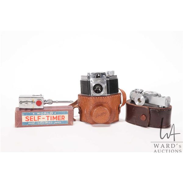 Vintage miniature camera and a selection of camera accessories including 1940's Konica Snappy Submin