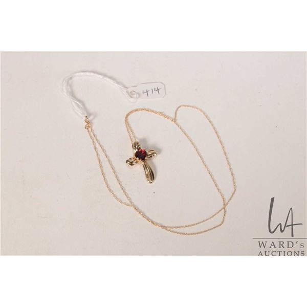 10kt yellow gold 18" fine neck chain and a 10kt yellow gold pendant set with red heart shaped gemsto