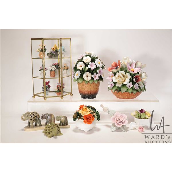 Five porcelain florals and a brass and glass display with miniature floral and two stone carvings in
