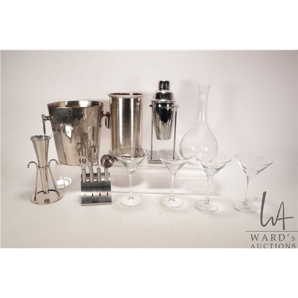 Selection of bar items including martini shaker and four martini glasses, strainer, mixers, glass wi