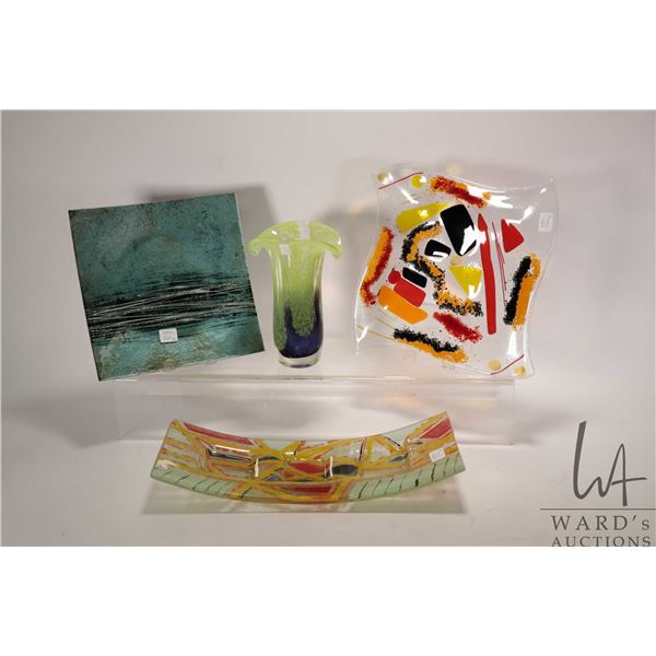 Three colourful art glass plates and a 8" art glass vase