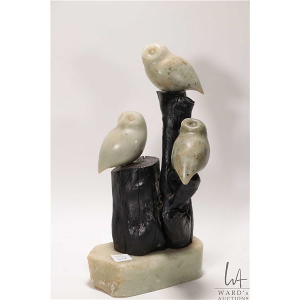 Soaptone carving of three owls on a wooden tree stamp with soapstone base, no artist signature seen,