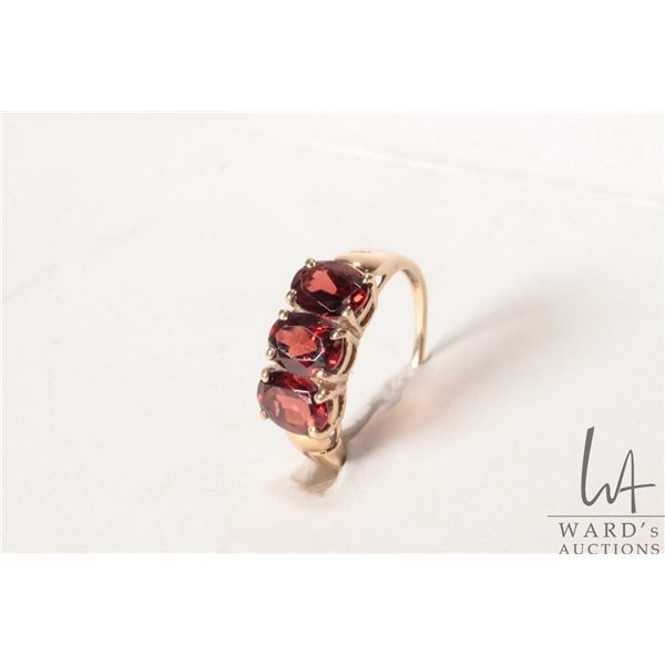 10kt yellow gold and three stone garnet ring, size 7