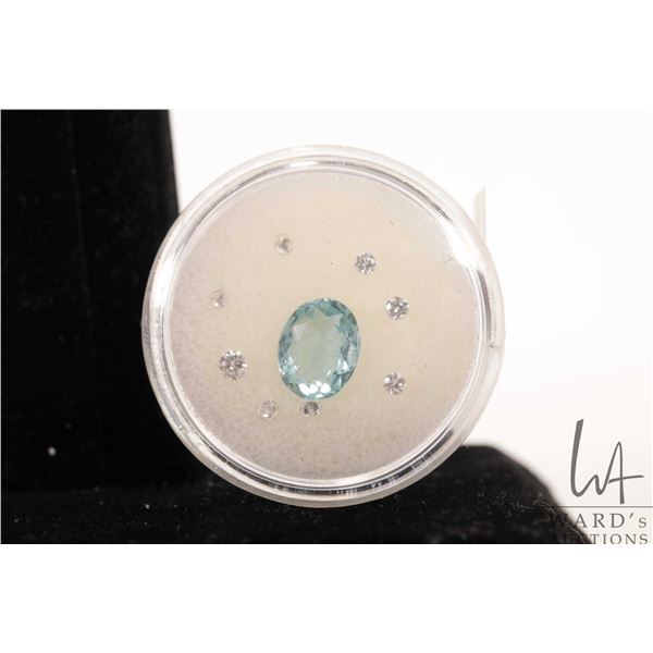 Loose citrine/ aqua blue oval cut gemstone and eight small gemstones that test as diamond