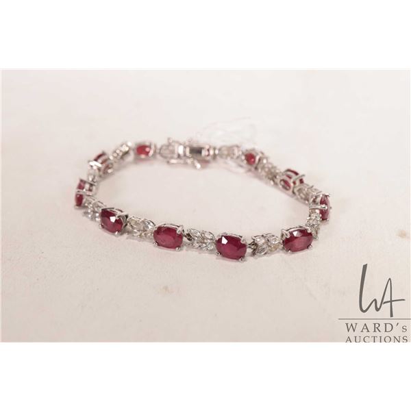 Sterling silver tennis bracelet set with ruby/ ruby like electronically tested gemstones, 7" in leng