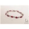 Image 1 : Sterling silver tennis bracelet set with ruby/ ruby like electronically tested gemstones, 7" in leng