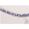 Image 2 : 14kt white gold, tanzanite and diamond bracelet. Set with 13.25 cts of oval mixed cut tanzanite gems