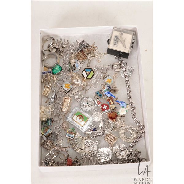 Two silver charms bracelets with a large selection of sterling and silver charms etc.