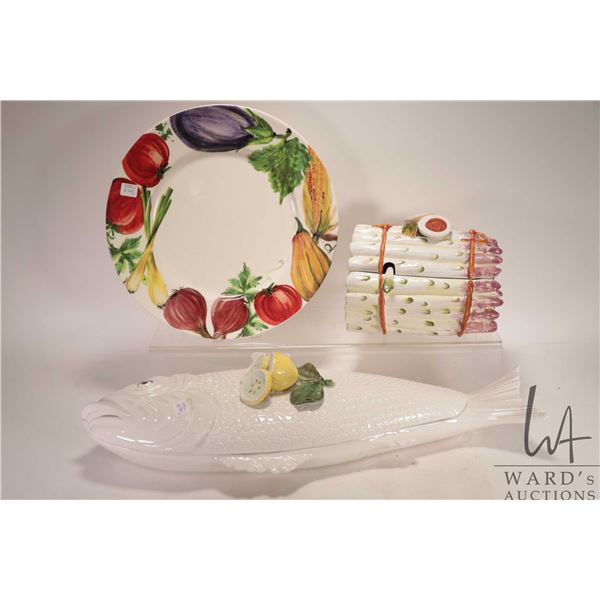 Three pieces of glazed ceramic serving pieces including 14 1/2" charger, asparagus motif lidded ture