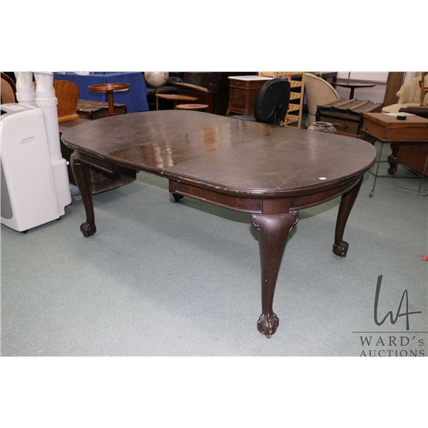 Antique mahogany crank table 48" X 52" plus one 17" insert leaf, with heavy ball and claw feet and i
