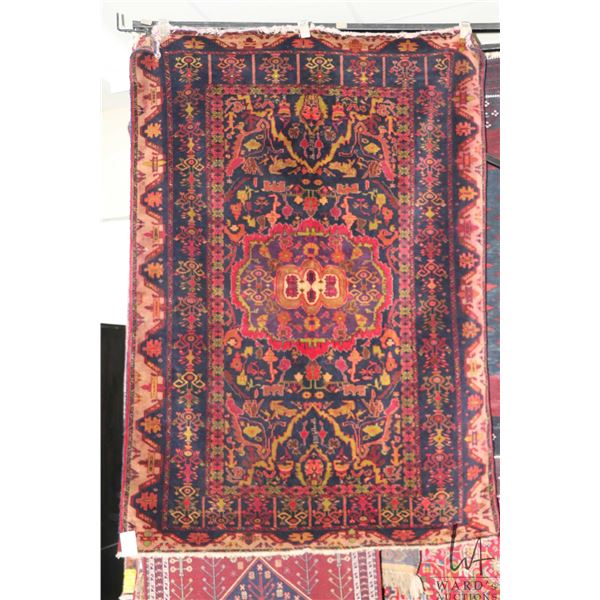 Vinatge wool area carpet with deep red back background and highlights of black, cream, green etc. 51