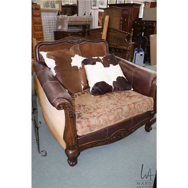 Well loved chair and a half with calf hide pillows
