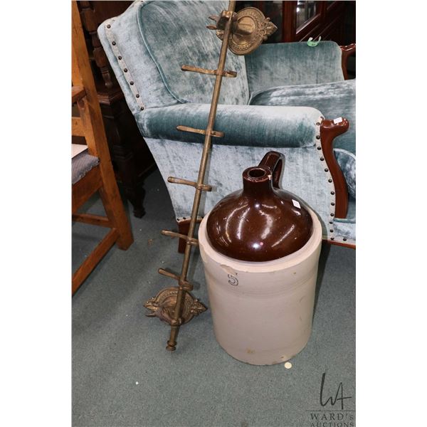Five gallon stoneware jug and a horse motif wall mount coat rack. Note: Not available for shipping. 