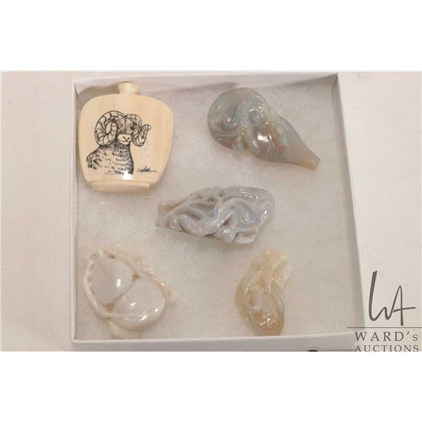Selection of small handcarved items including scrimshaw perfume and what appears to be carved opal