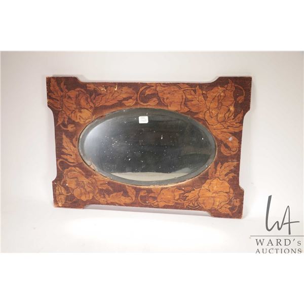Antique beveled mirror in hand burned floral and stipple finish. Outside dimensions 16"x23". Note: N