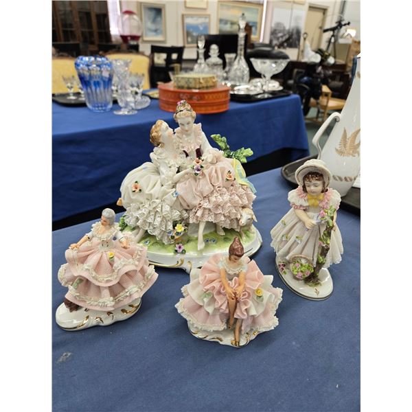 Four Dresden figurines including dancers, pair of ladies on a bench etc. ranging from 3 1/2" to 7" i