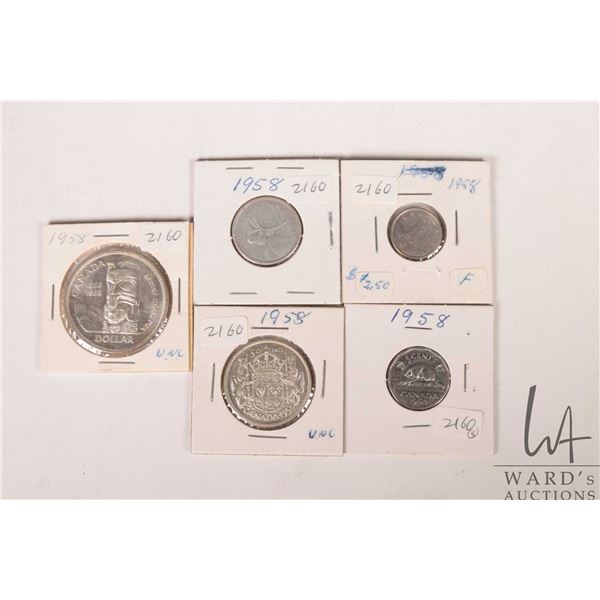 Five Canadian 1958 coins including nickel, dime, quarter, fifty cent and silver dollar