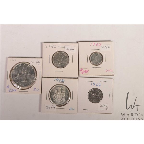 Five Canadian 1962 coins including nickel, dime, quarter, fifty cent and silver dollar