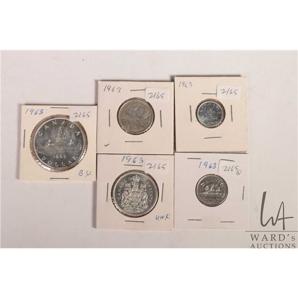 Five Canadian 1963 coins including nickel, dime, quarter, fifty cent and silver dollar