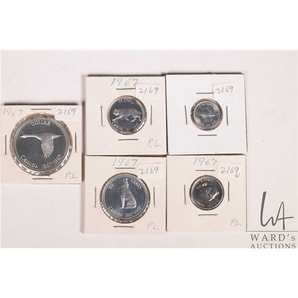 Five Canadian 1967 coins including nickel, dime, quarter, fifty cent and silver dollar