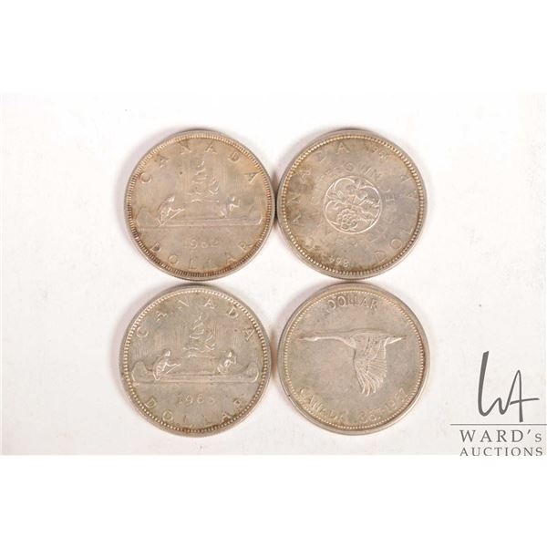 Four Canadian silver dollars including 1962, 1964, 1964 and 1967